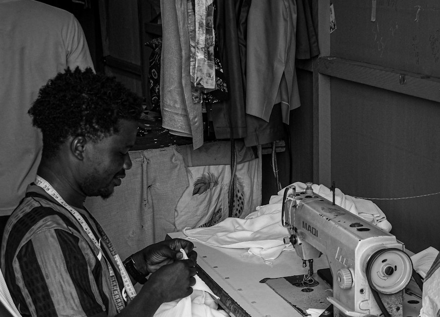 A Ghanaian tailor working at his sewing machine