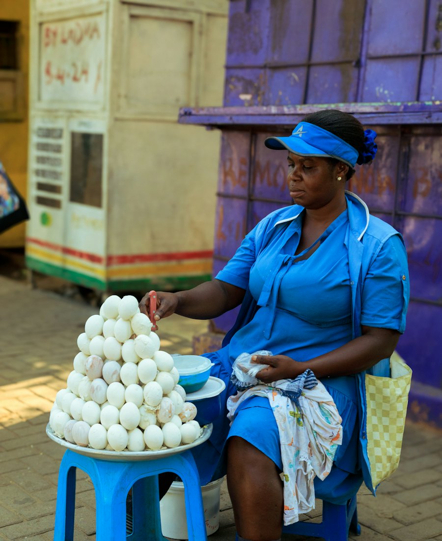 A Ghanaian trader arranging eggs at her market stall
